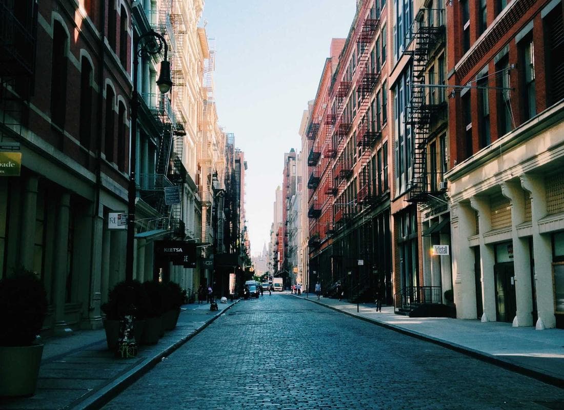 A red-brick city street of homes